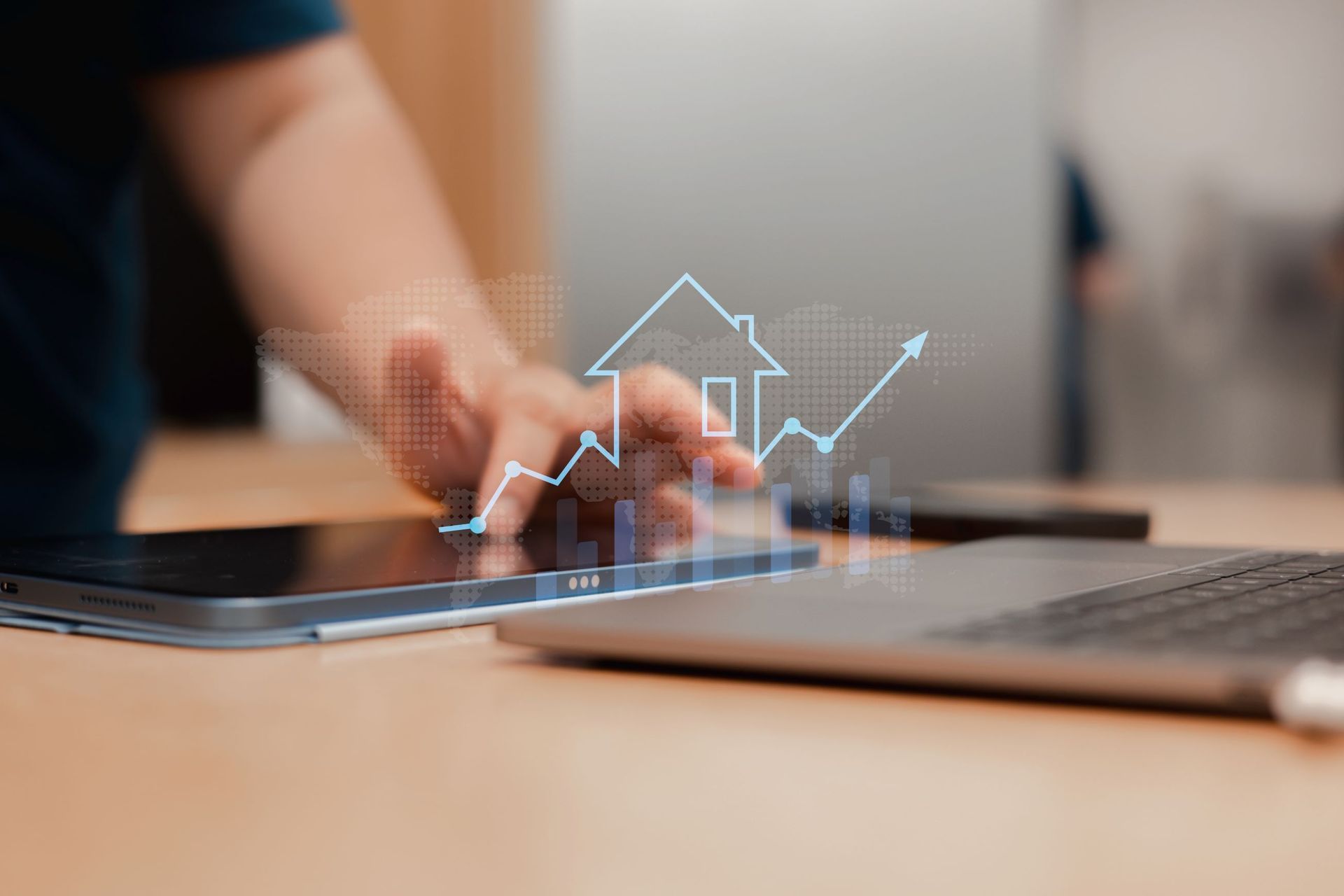 A Person Is Using A Tablet With A House And A Graph On It