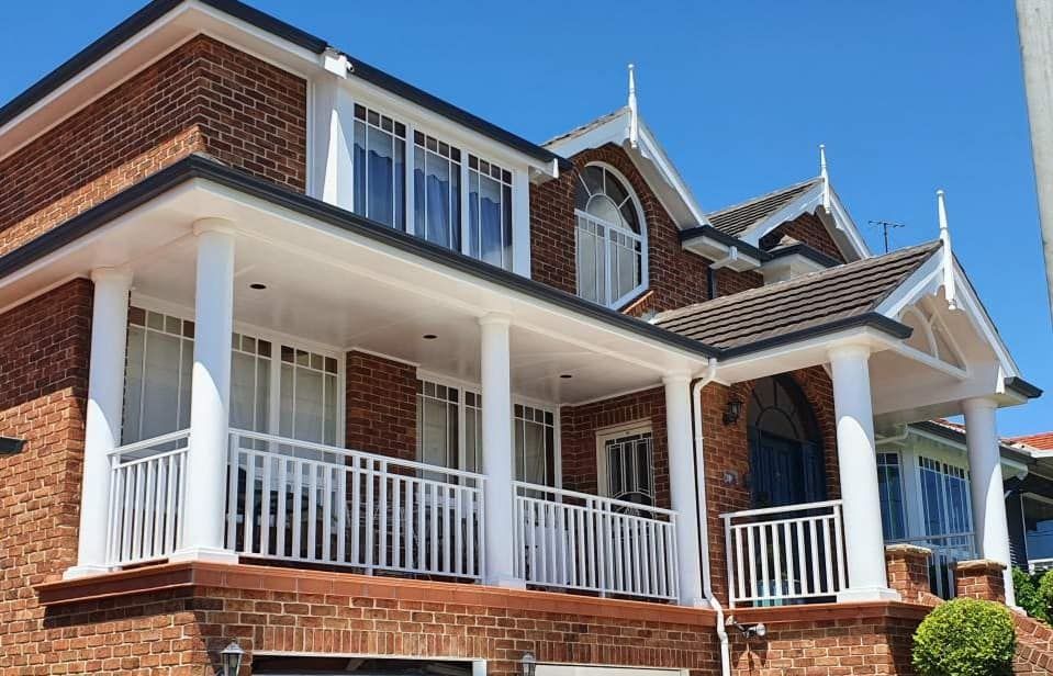Large Brick House With A Large Porch And White Railing — Decorative Aluminium Works In Hunter Valley, NSW