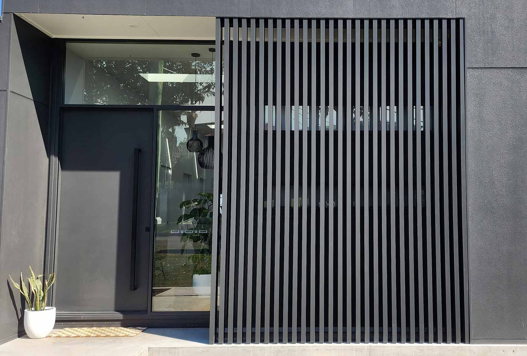 Modern House With A Black Door And A Black Fence — Decorative Aluminium Works In Cardiff, NSW