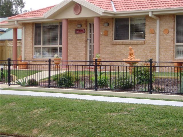 Brick House With A Black Decorative Fence In Front — Decorative Aluminium Works In Cardiff, NSW