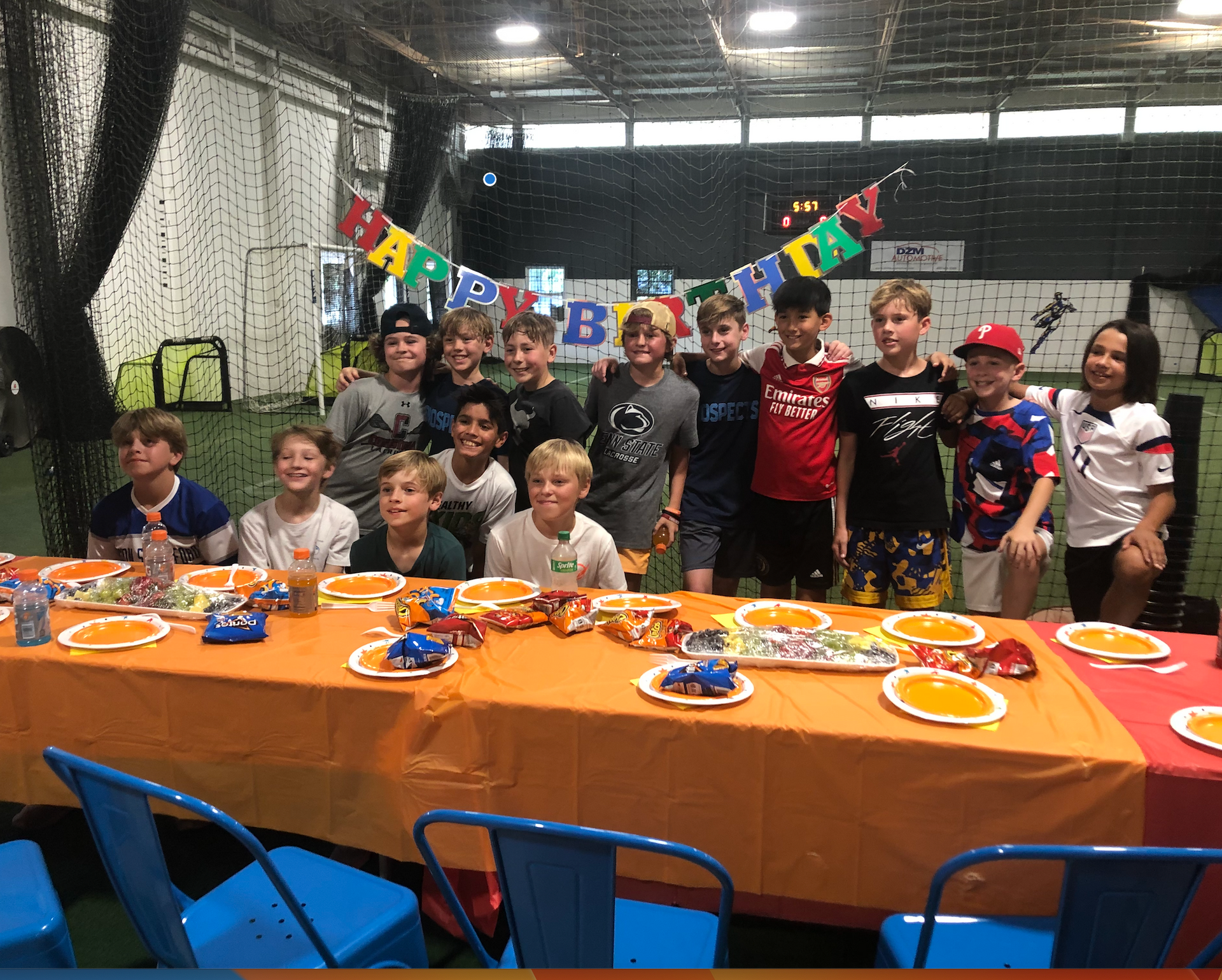 A group of children are posing for a picture at a birthday party.