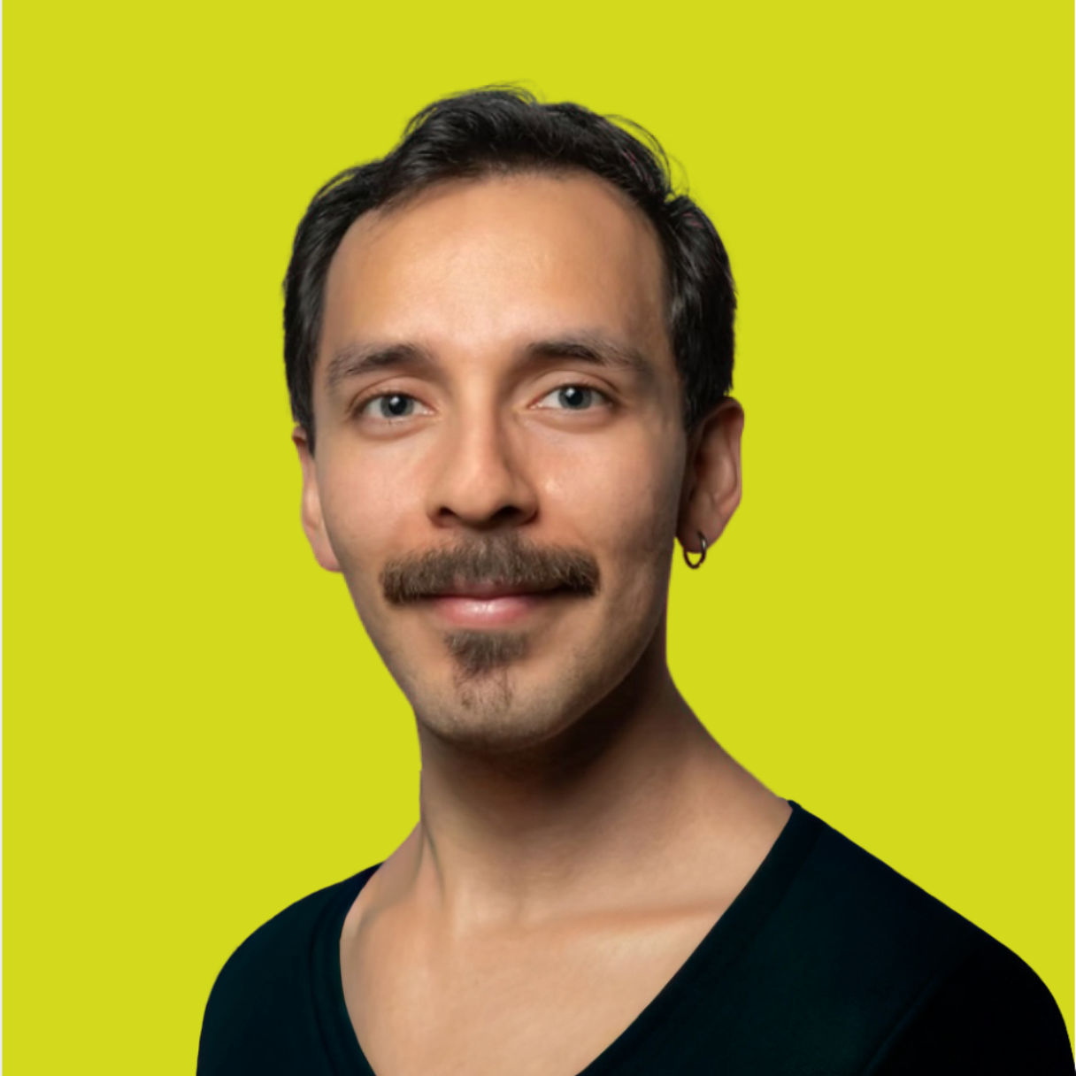Closeup of a man with short dark hair and mustache with a bright yellow and green background.