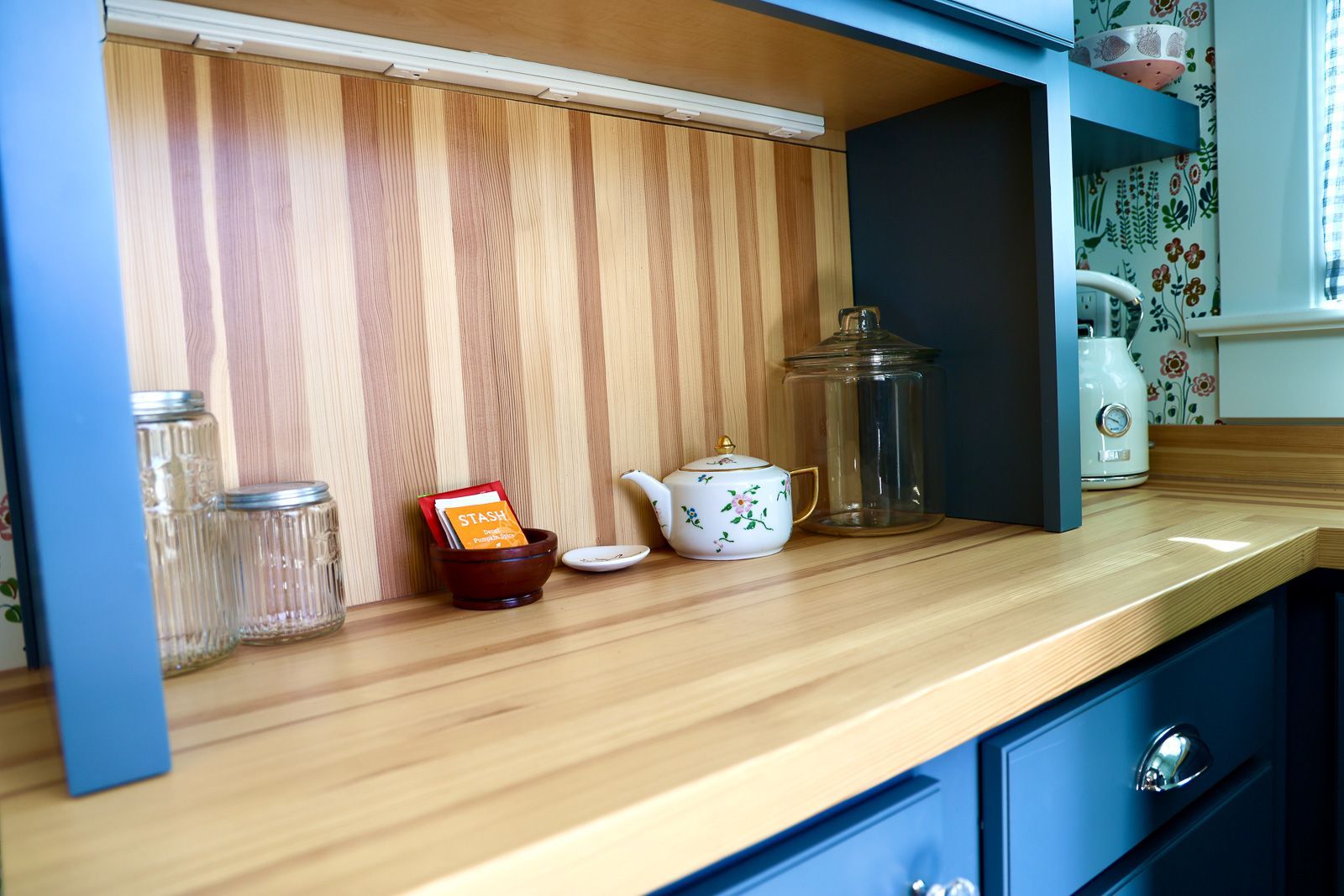 Reclaimed Douglas fir countertop, detail view of the wood surface and edge against navy cabinetry. Story City, Iowa.