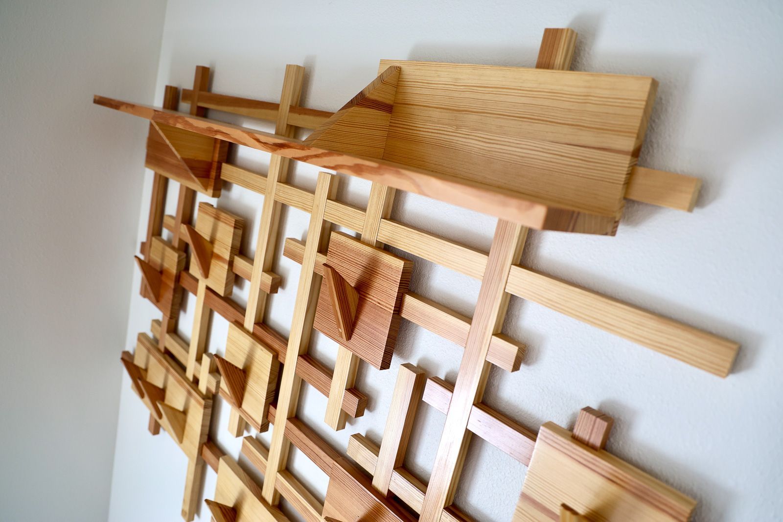 Stagger coat rack in reclaimed Douglas fir, an offset grid of angular pegs, wall mounted in Story City, Iowa. 