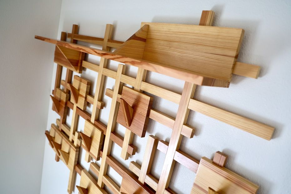 Stagger coat rack in reclaimed Douglas fir, an offset grid of angular pegs, wall mounted in Story City, Iowa.