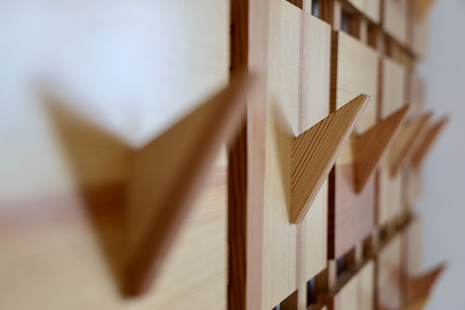 up close view of the Array coat rack in reclaimed Douglas fir, angular hooks  on an even grid. Story City, Iowa.