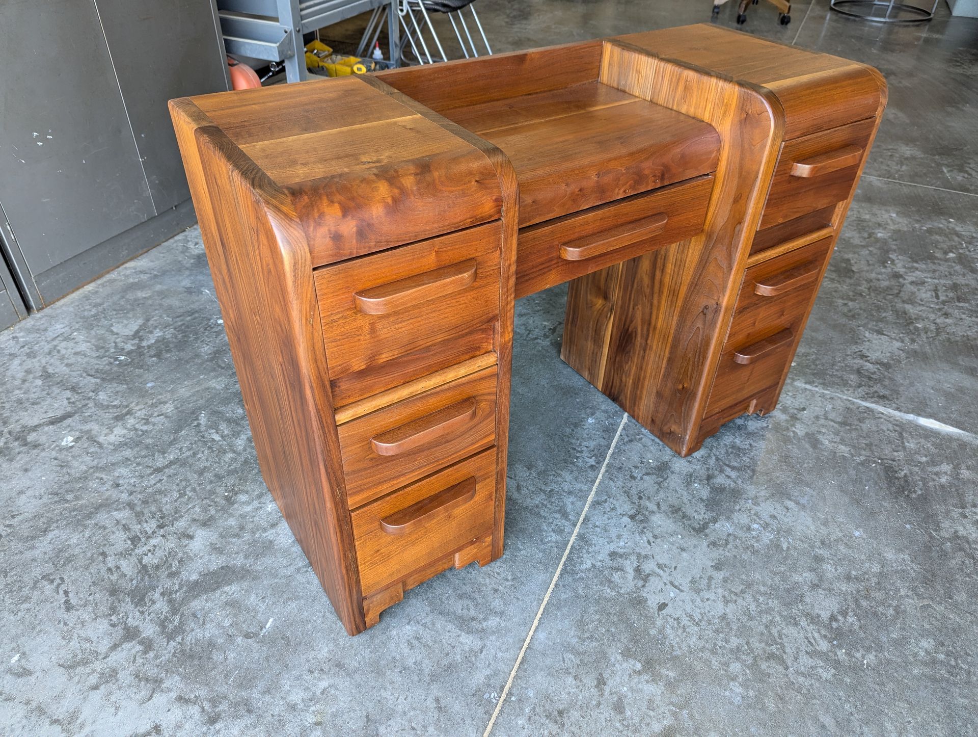 Restored mid-century walnut desk with curved edges, showcasing custom furniture restoration by Crow and Timber.