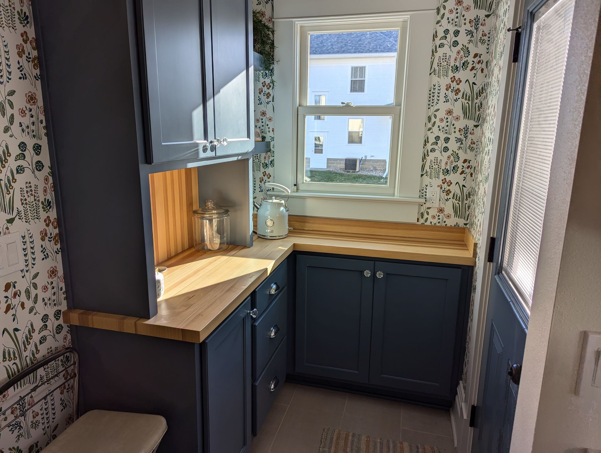 Custom kitchen nook with countertops and a matching backsplash, made from reclaimed wood flooring, by Crow and Timber.
