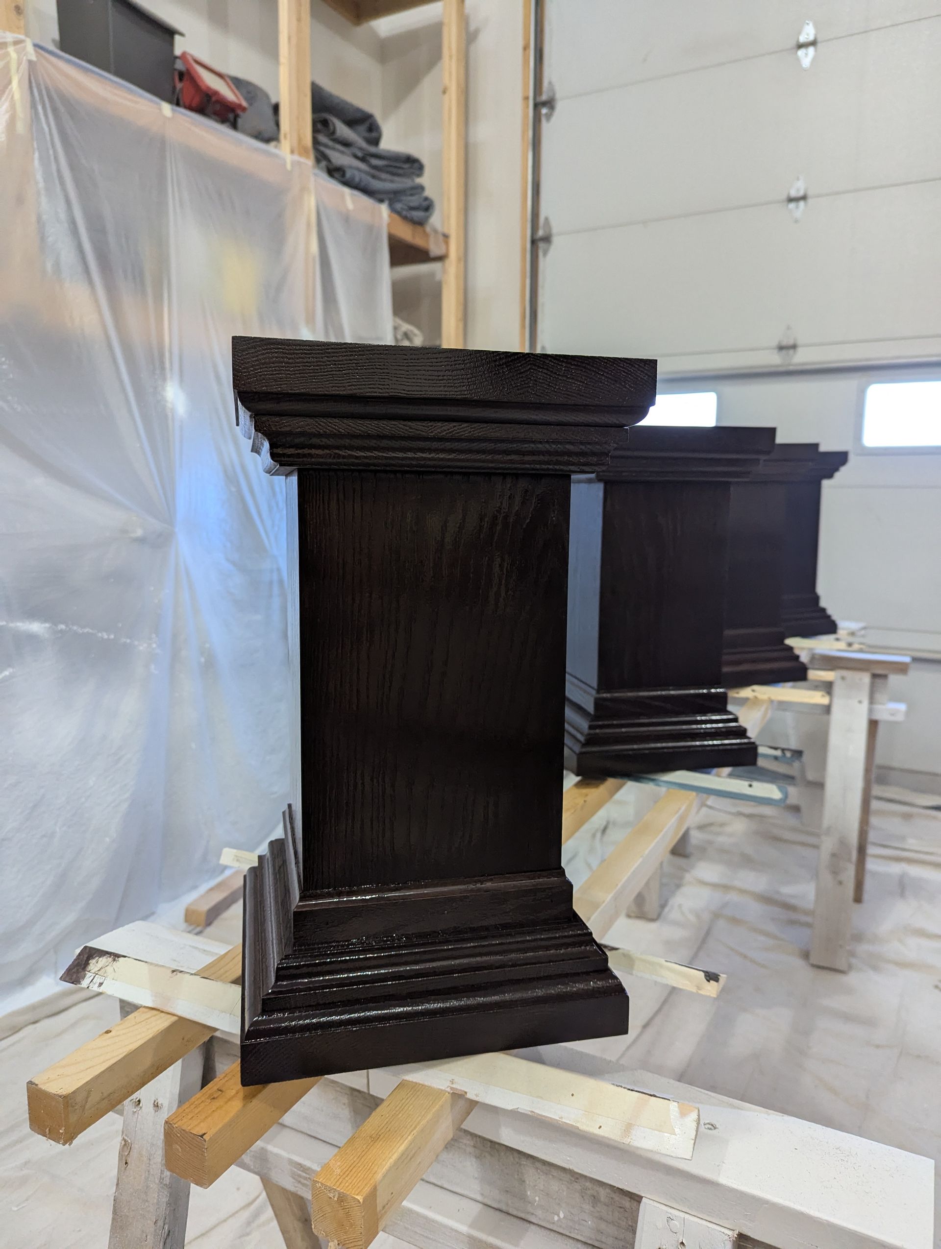 Rebuilt wooden pool table legs,  drying in a woodworking shop, showcasing restoration and craftsmanship by Crow and Timber.