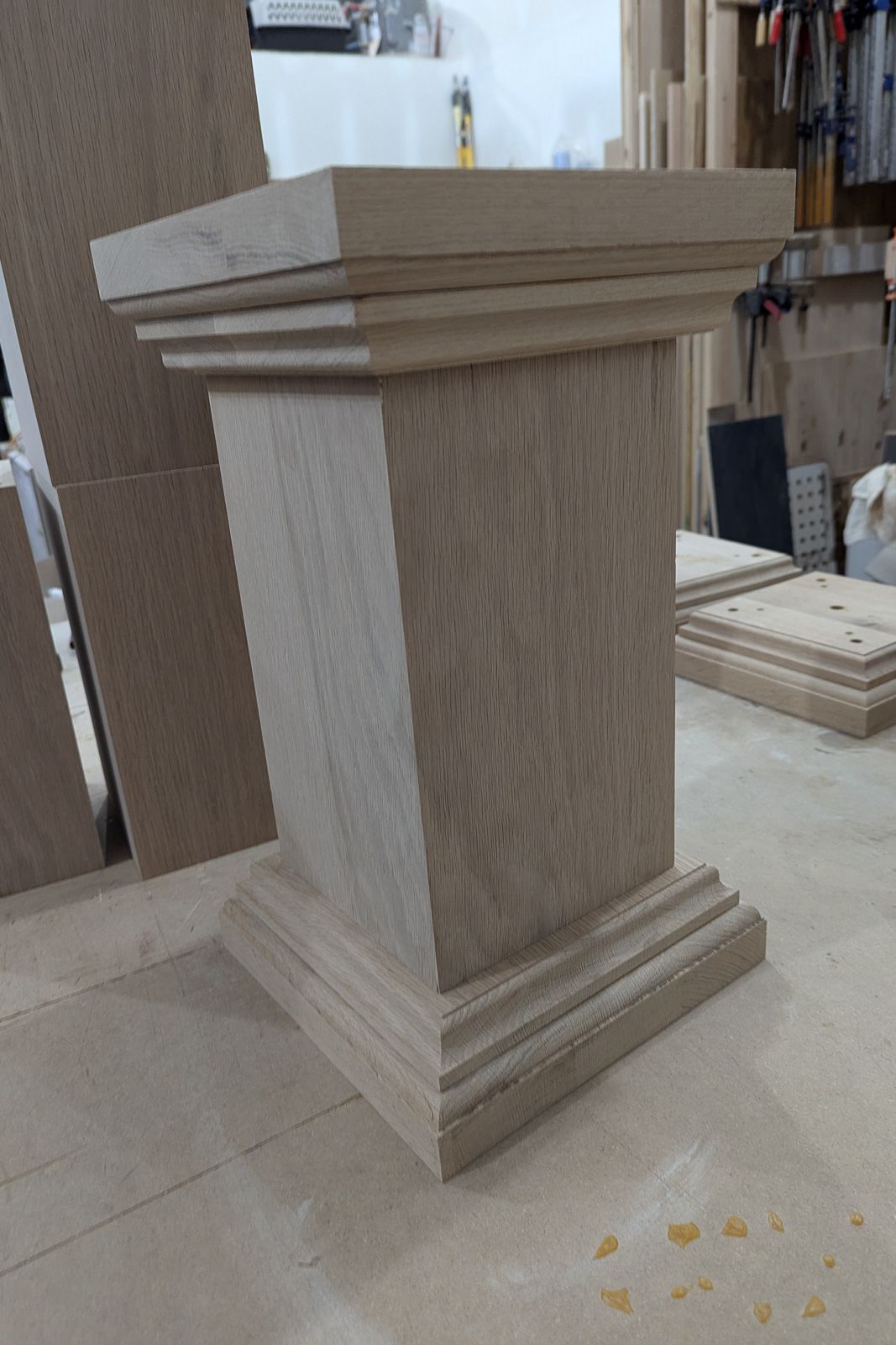 White oak plinth base with stepped molded detail, in the Crow and Timber shop. Nevada, Iowa.
