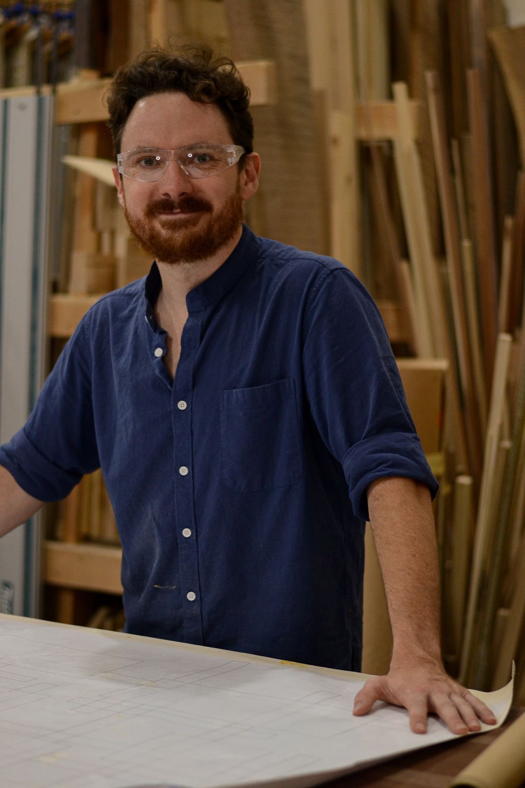Jonas Christian, founder of Crow and Timber, at the drawing bench in his Nevada, Iowa furniture studio