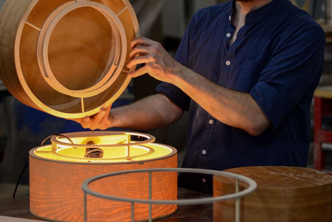 Assembling a hardwood lamp shade at the bench in the Crow and Timber shop in Nevada, Iowa