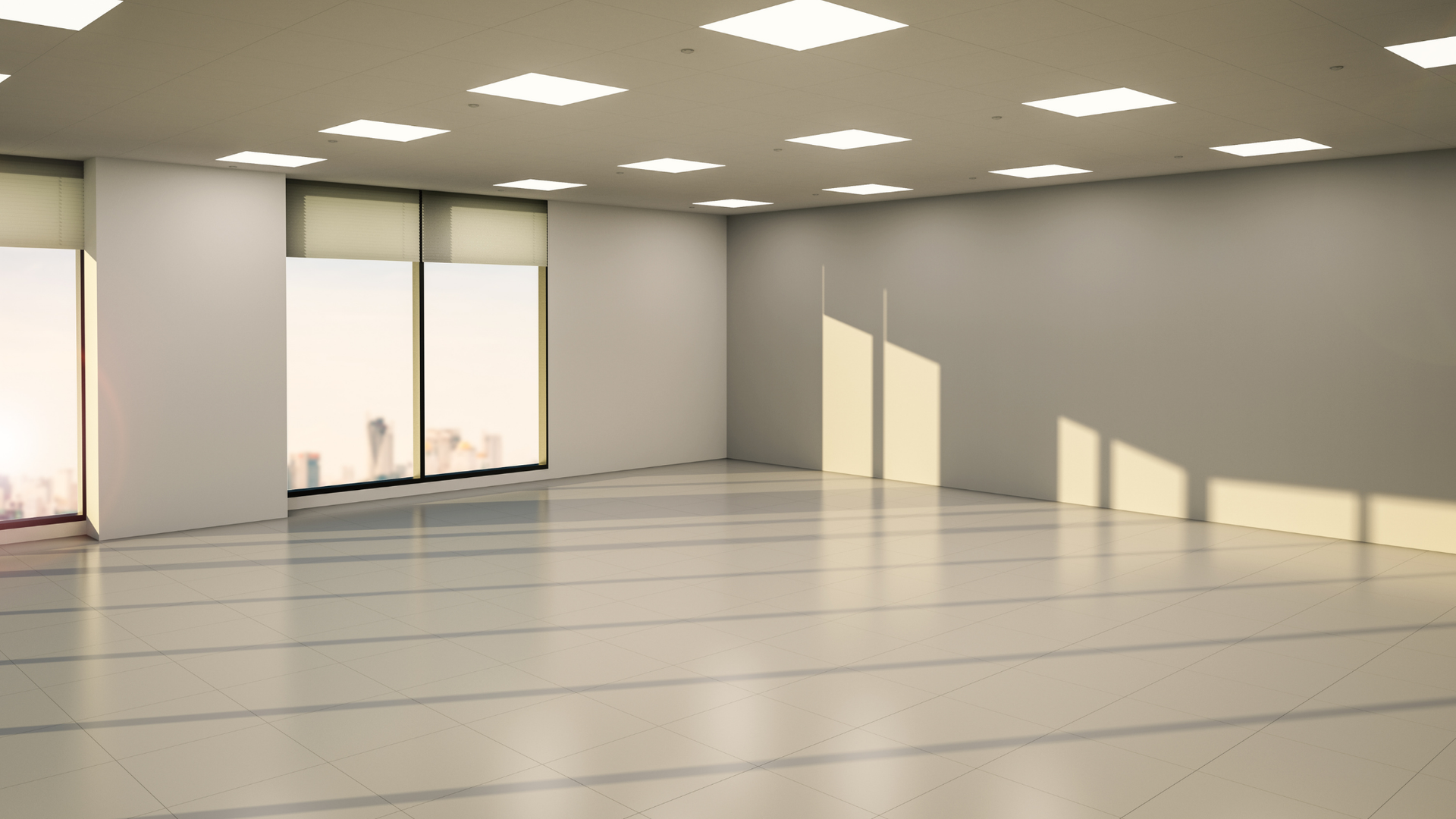 Empty beige room with large windows and sunlight casting long shadows across the floor