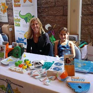 Woman and girl at a table with pool safety for stop drowning now