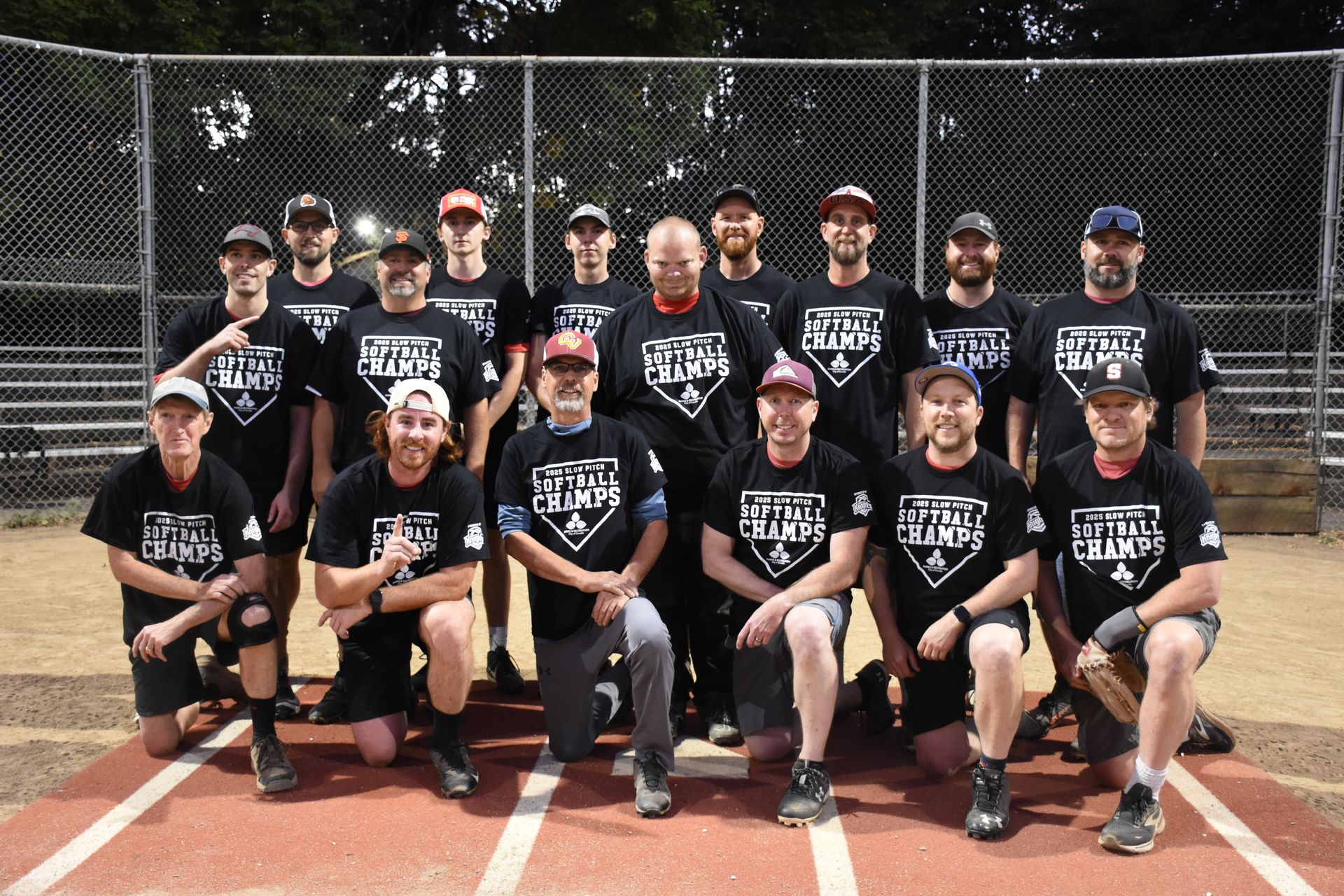 A men's softball team in matching black 