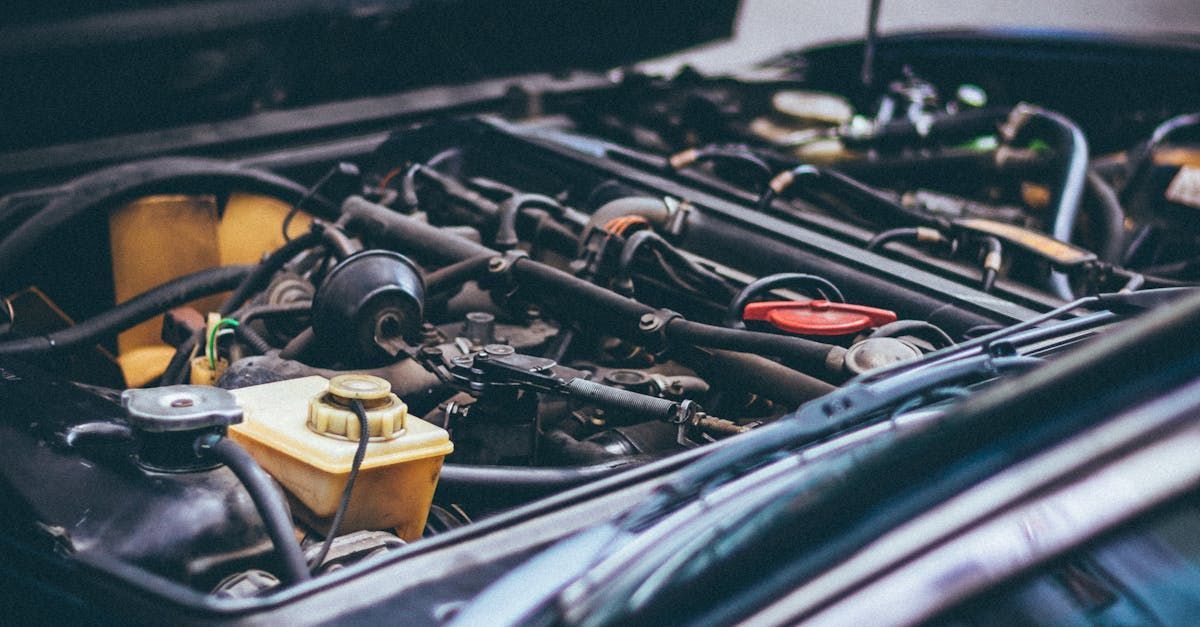 A close up of a car engine with the hood open.