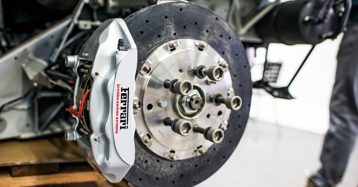 A close up of a ferrari brake disc on a car.
