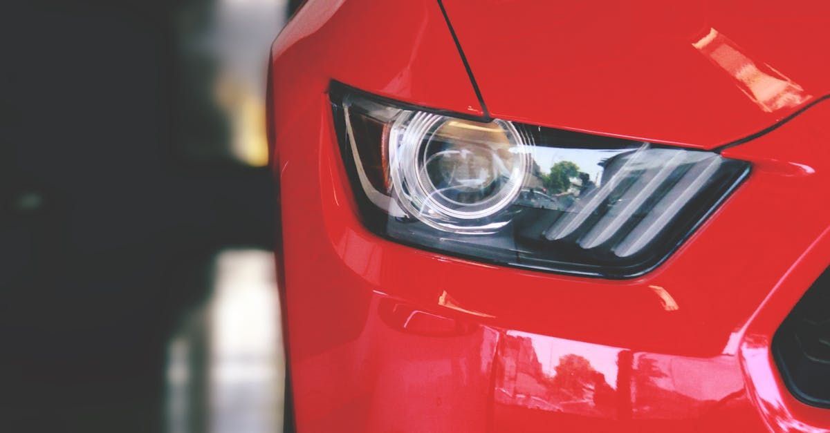 A close up of a red car 's headlight.