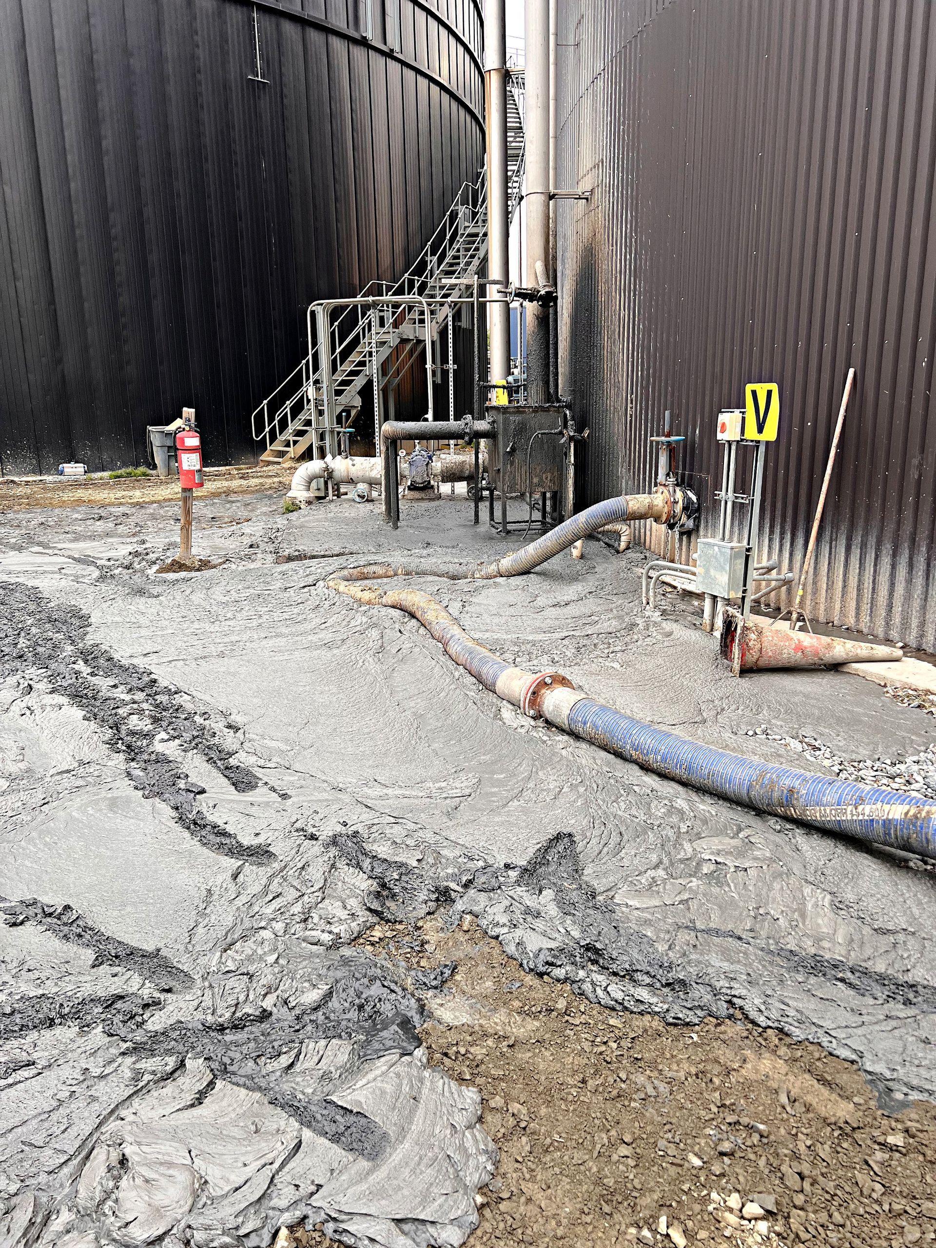 Emergency containment equipment deployed at an industrial site following a hazardous material release during demolition