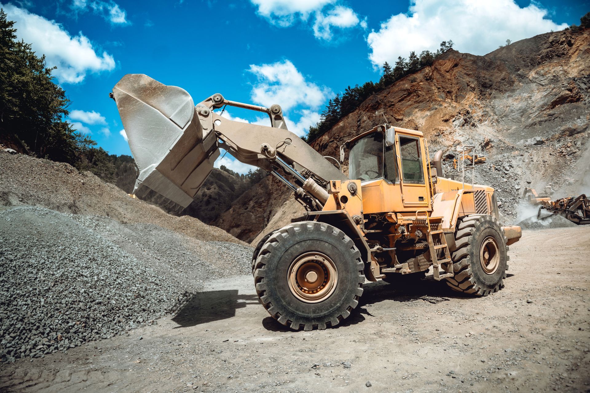 Wheel loader moving non-hazardous mineral processing waste and debris at an active mining operation