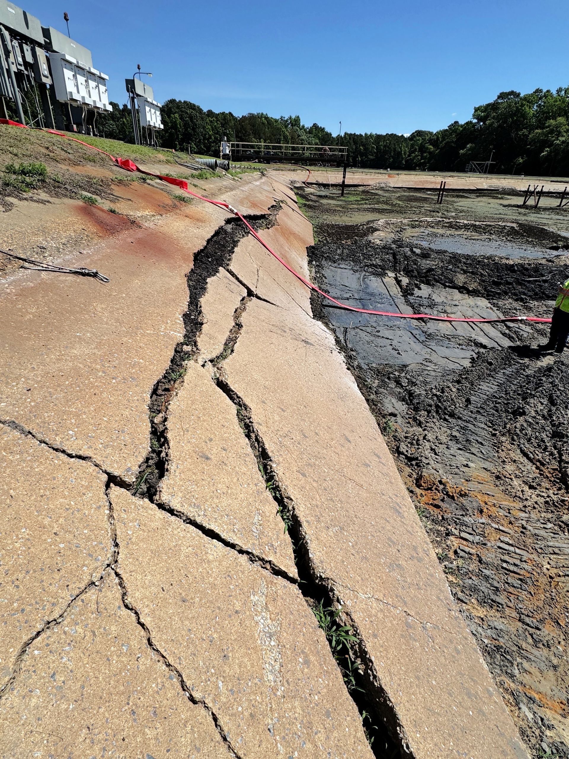 Cracked 16-foot concrete skirt with soil eroded underneath sliding into aeration basin at a North Carolina wastewater facility