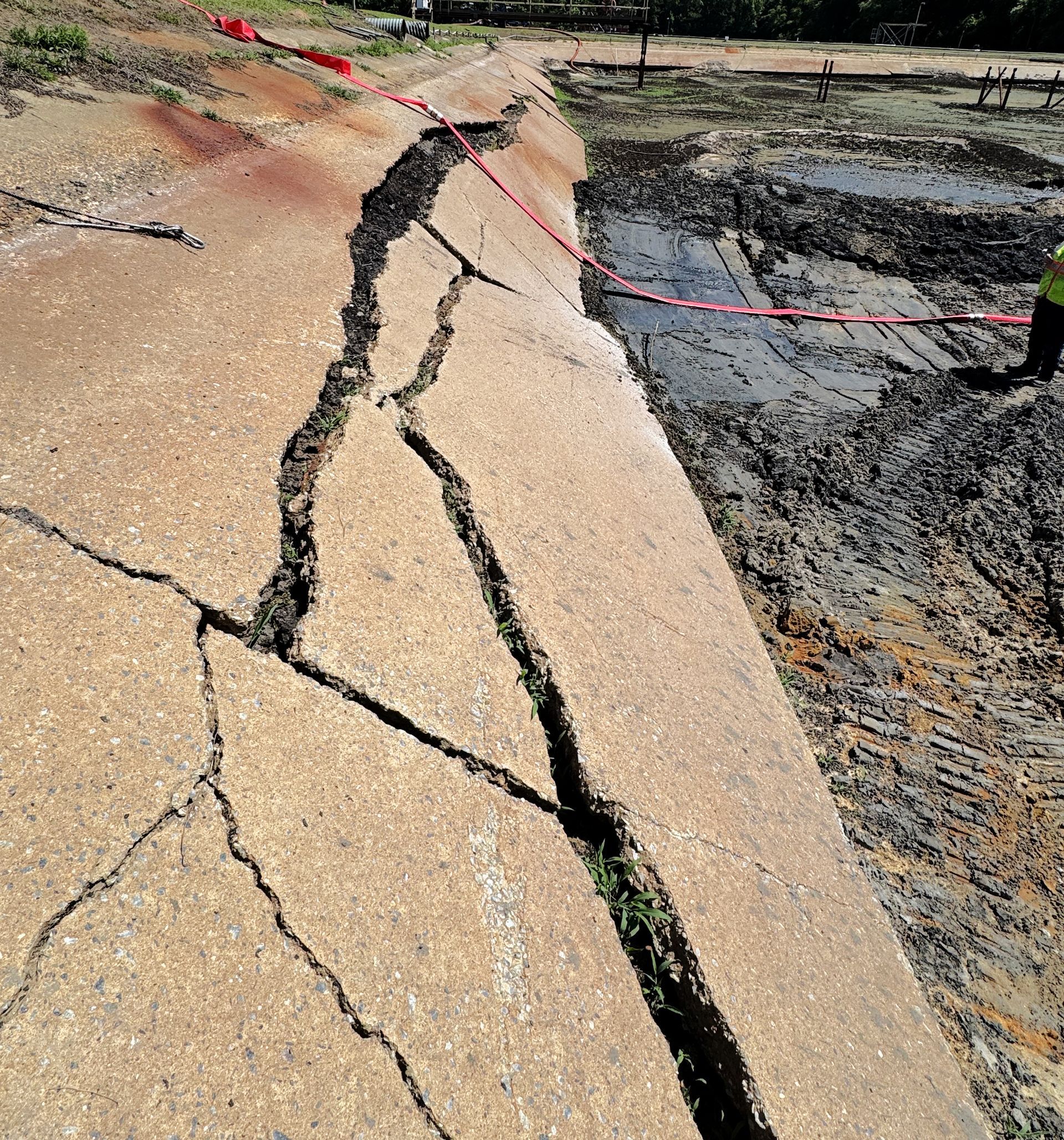 Cracked 16-foot concrete skirt with soil eroded underneath sliding into aeration basin at a North Carolina wastewater facility