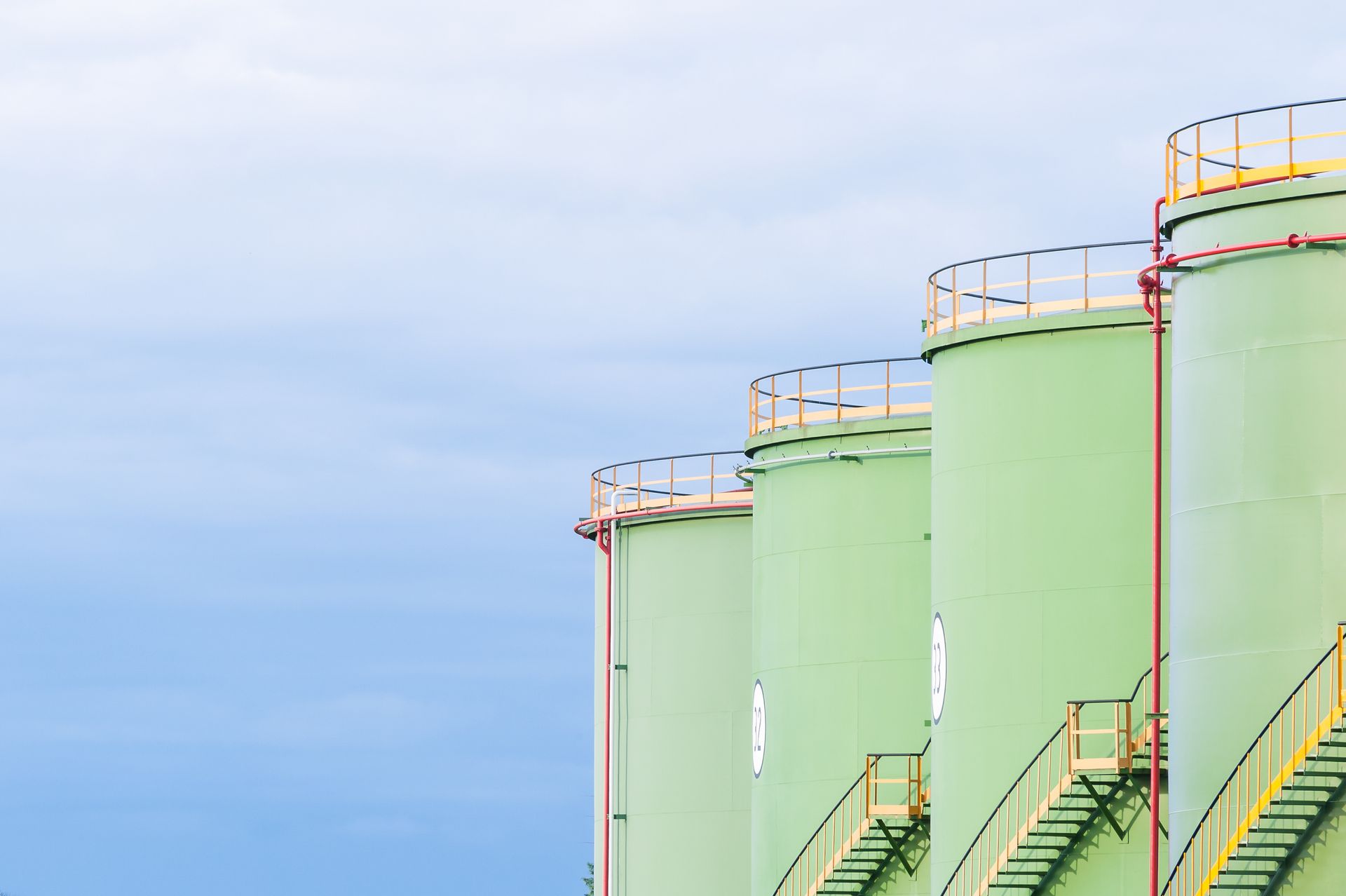 Aboveground industrial oil storage tanks prepared for compliant industrial tank cleaning operations
