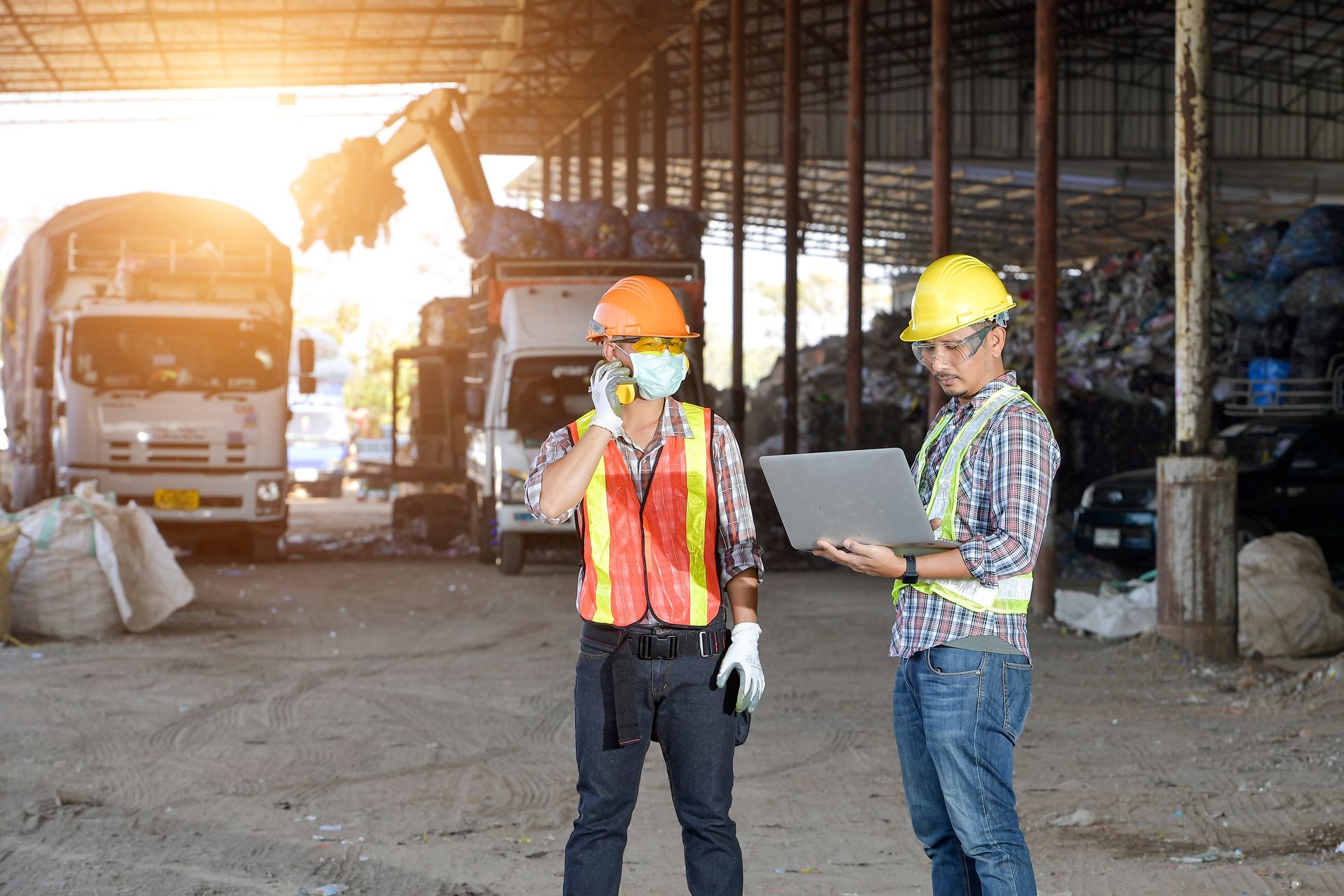Workers coordinating metal scrap and process byproduct recovery at an industrial recycling and material diversion facility
