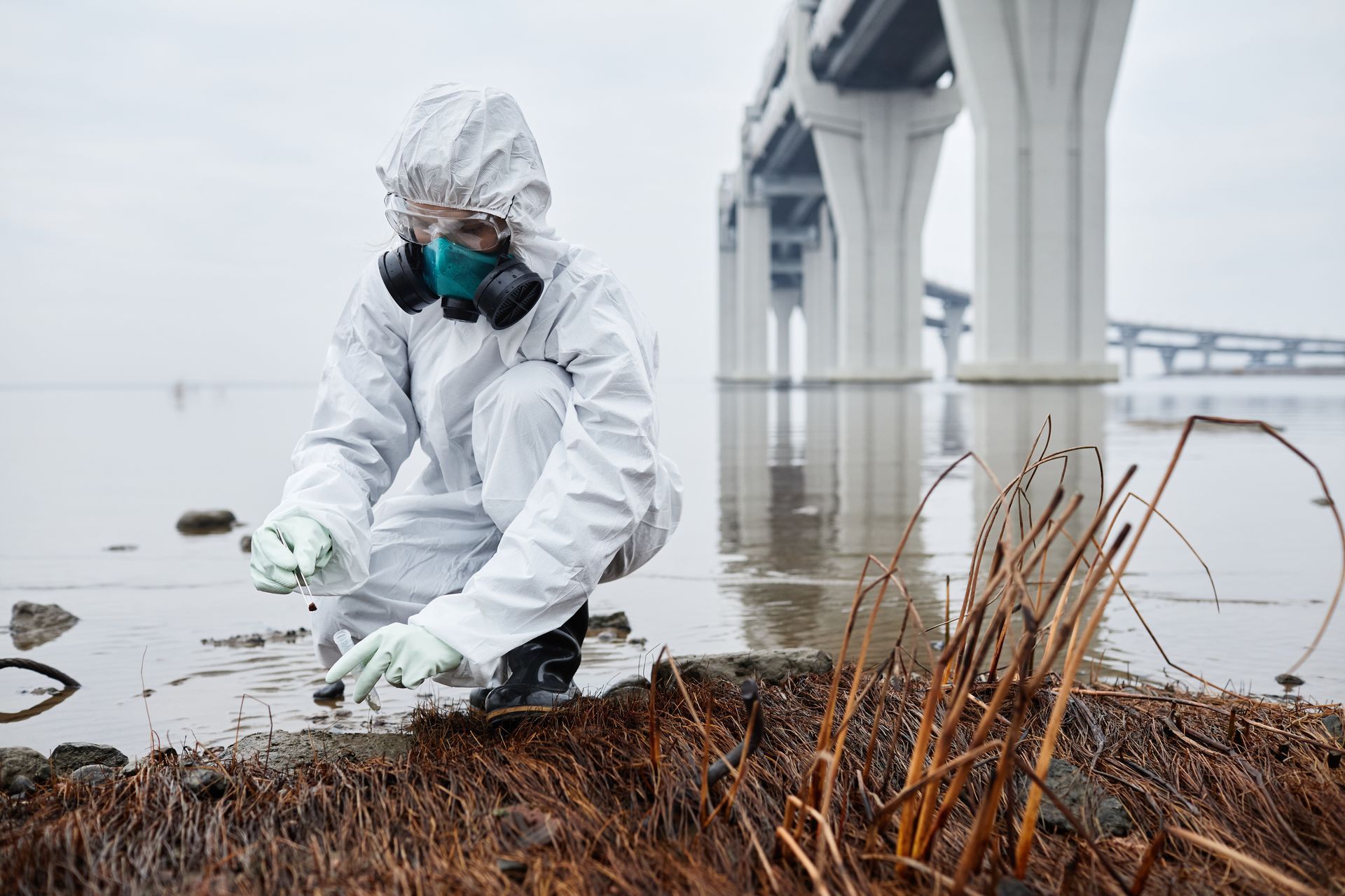 Technician collecting contaminated soil during site remediation and environmental cleaning services