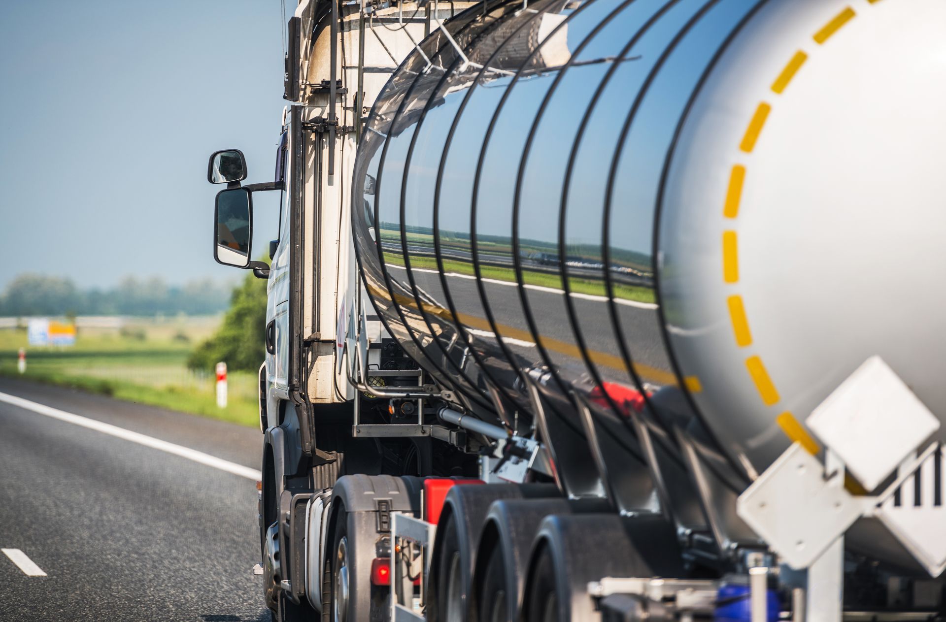 Hazardous waste tanker truck transporting regulated chemical waste from an industrial chemical processing facility