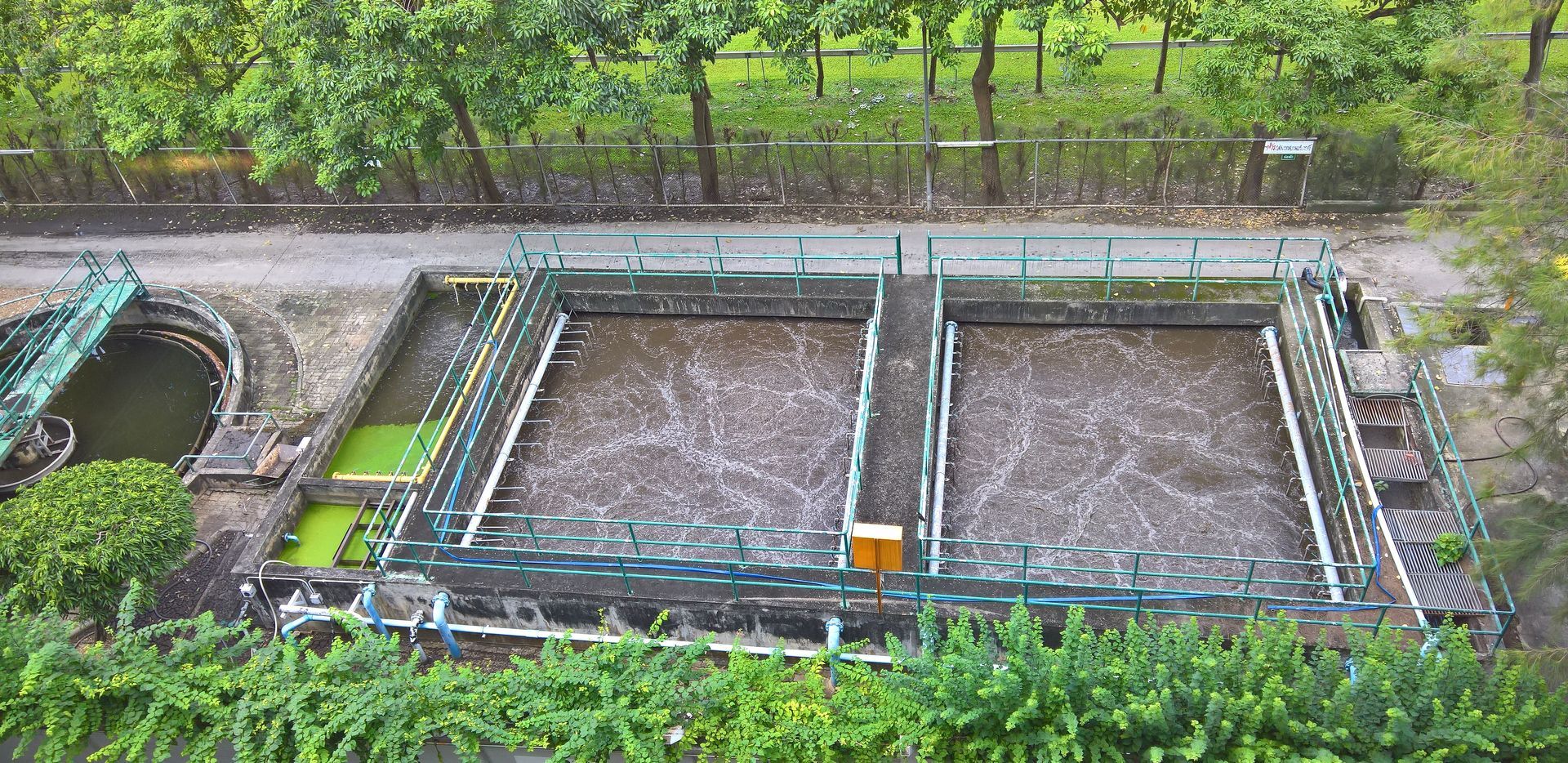 Industrial wastewater lagoons undergoing pond and lagoon cleanout for compliant sludge and water treatment removal