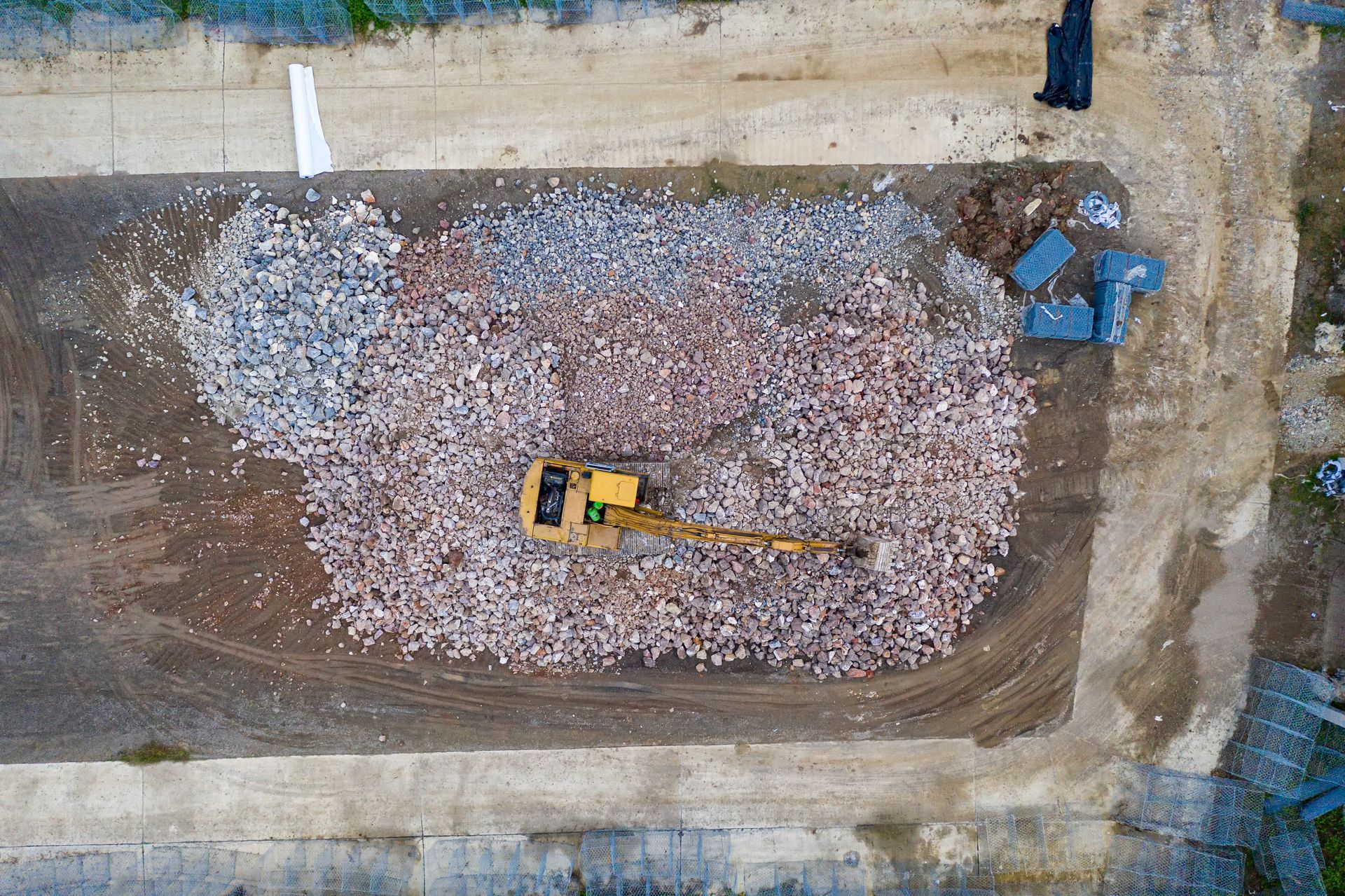 Aerial view of heavy equipment performing industrial plant dismantling and demolition debris removal