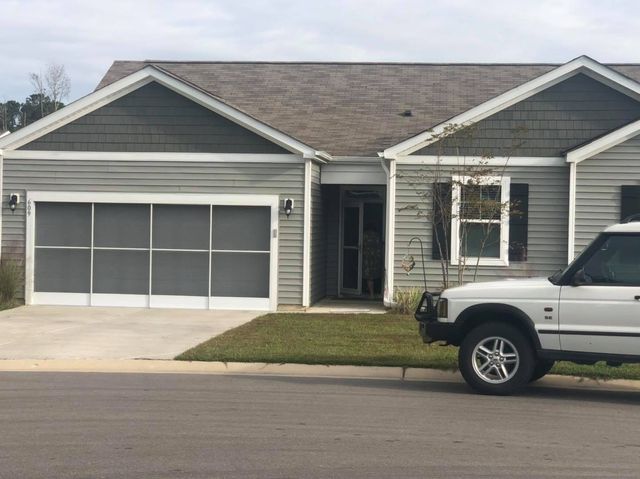 home with garage and car parked in front