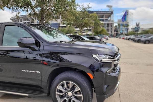 Tipper chauffeur greeting guests at airport