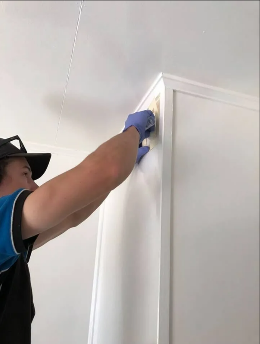 Man Fixing Wall In House