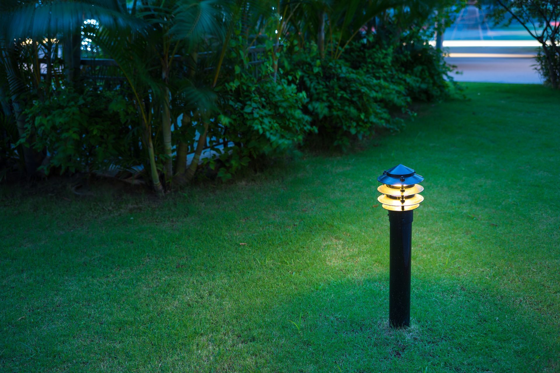 Illuminated grass path at night, showcasing S.A. Anderson Electric's landscape lighting installation
