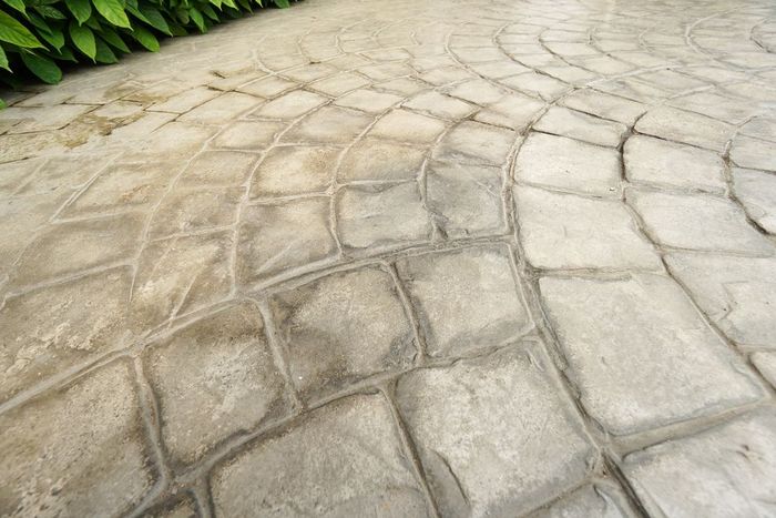A close up of a concrete walkway with a pattern on it.