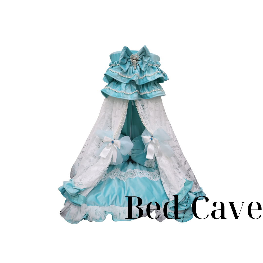 Blue lace bed canopy with ruffled curtains and a bow, labeled “Bed Cave”