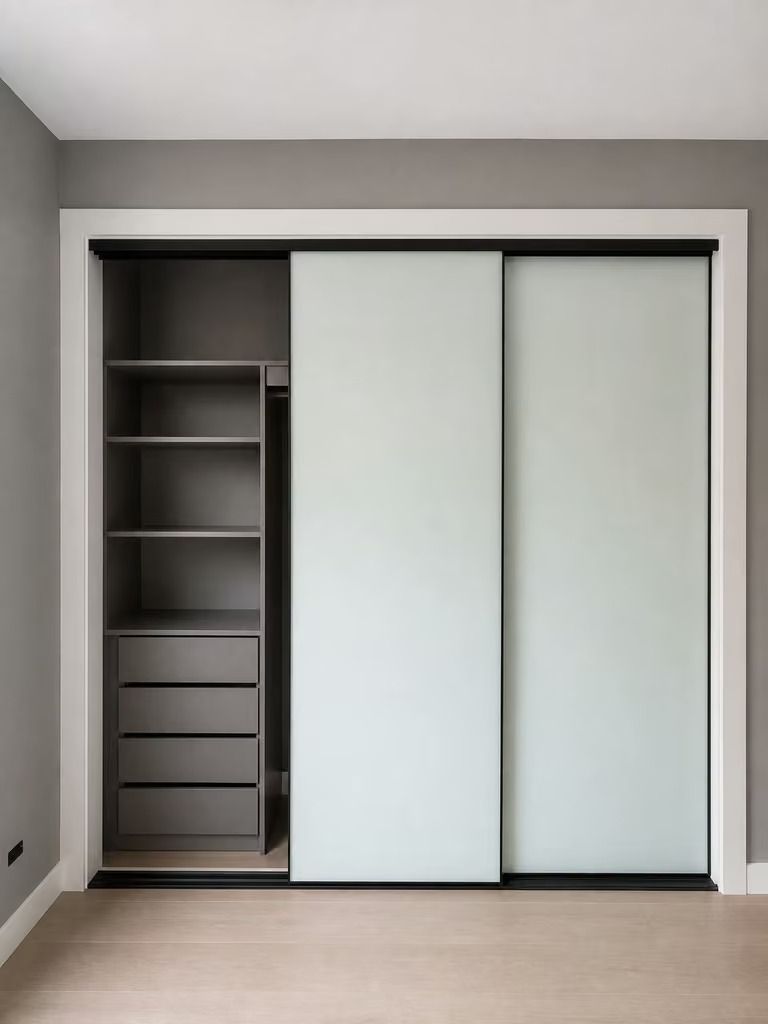 Built-in closet with open shelving and two white sliding doors in a gray room