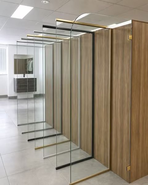 Modern glass and wood office partition wall with framed transparent panels in a hallway
