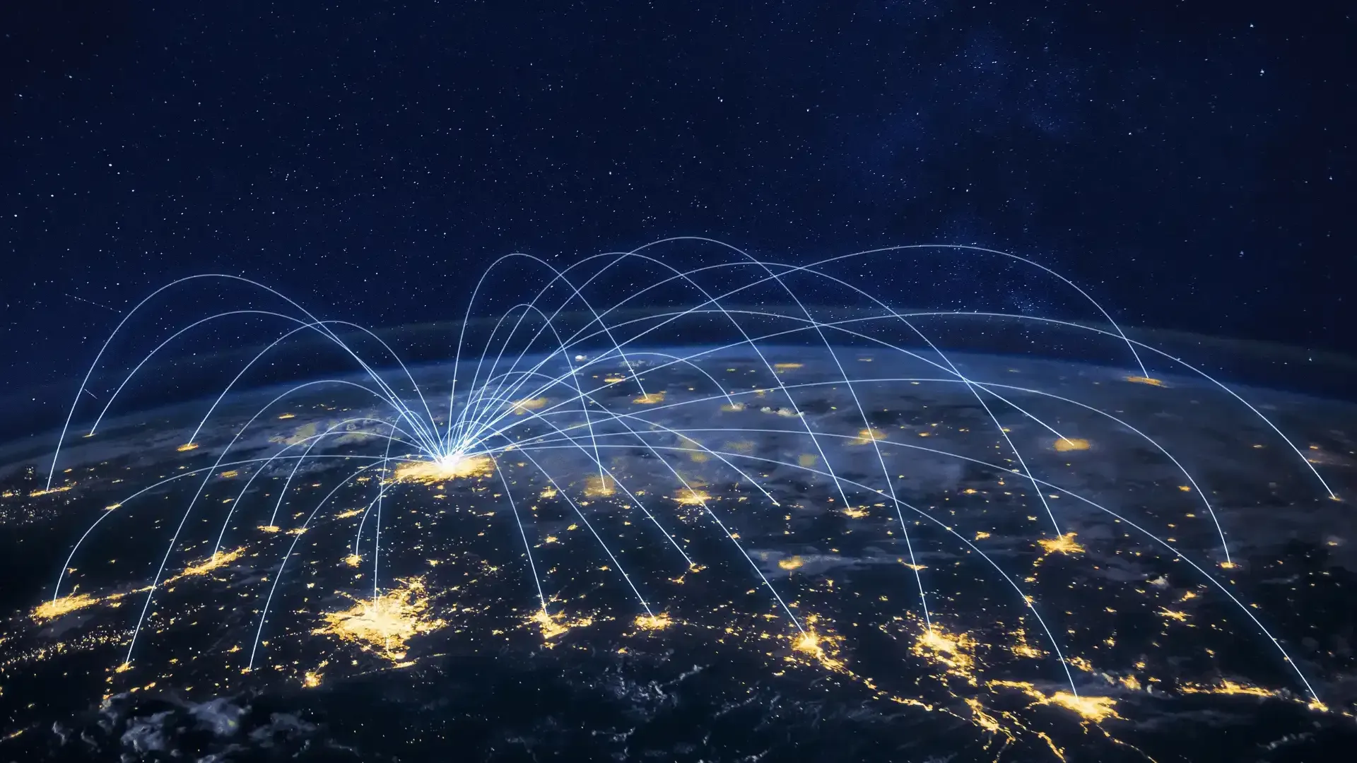 An aerial view of the earth at night with lots of connections.