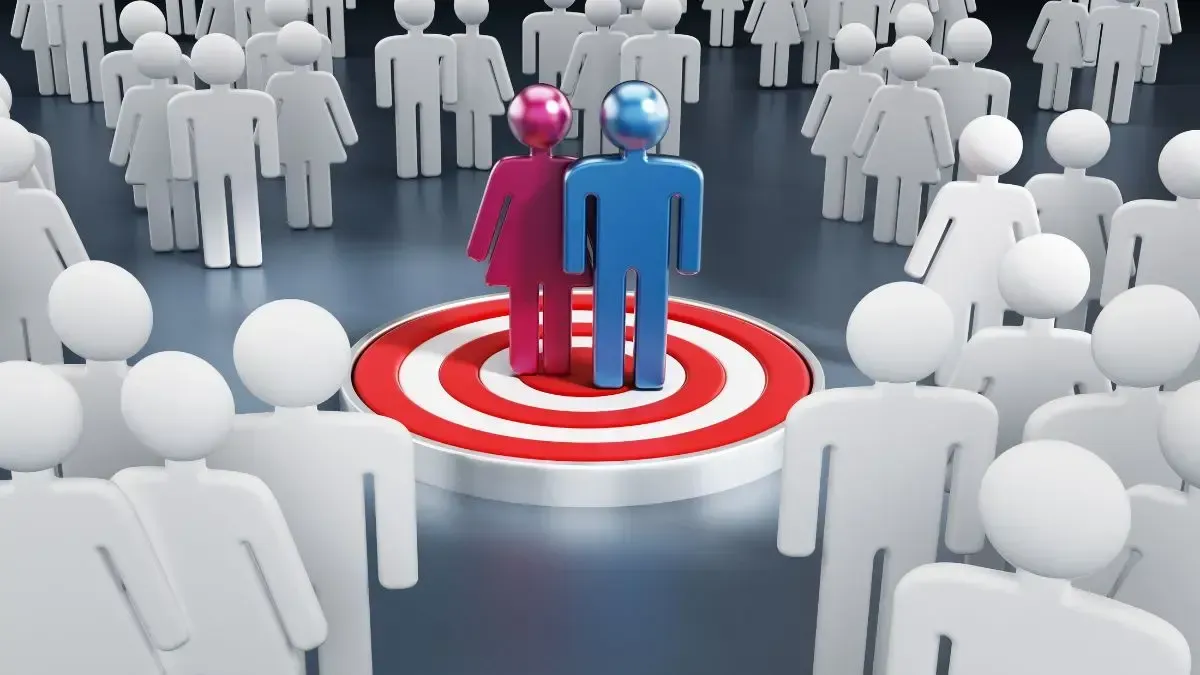 A man and a woman are standing in front of a target