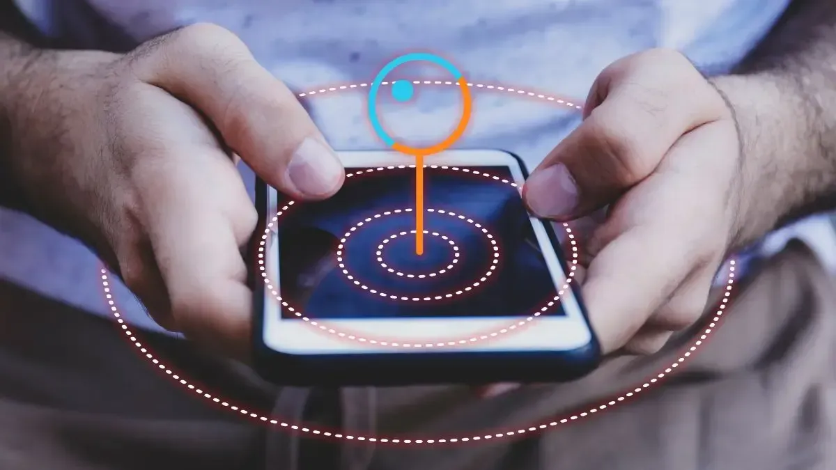 A person is holding a cell phone with a target on the screen.