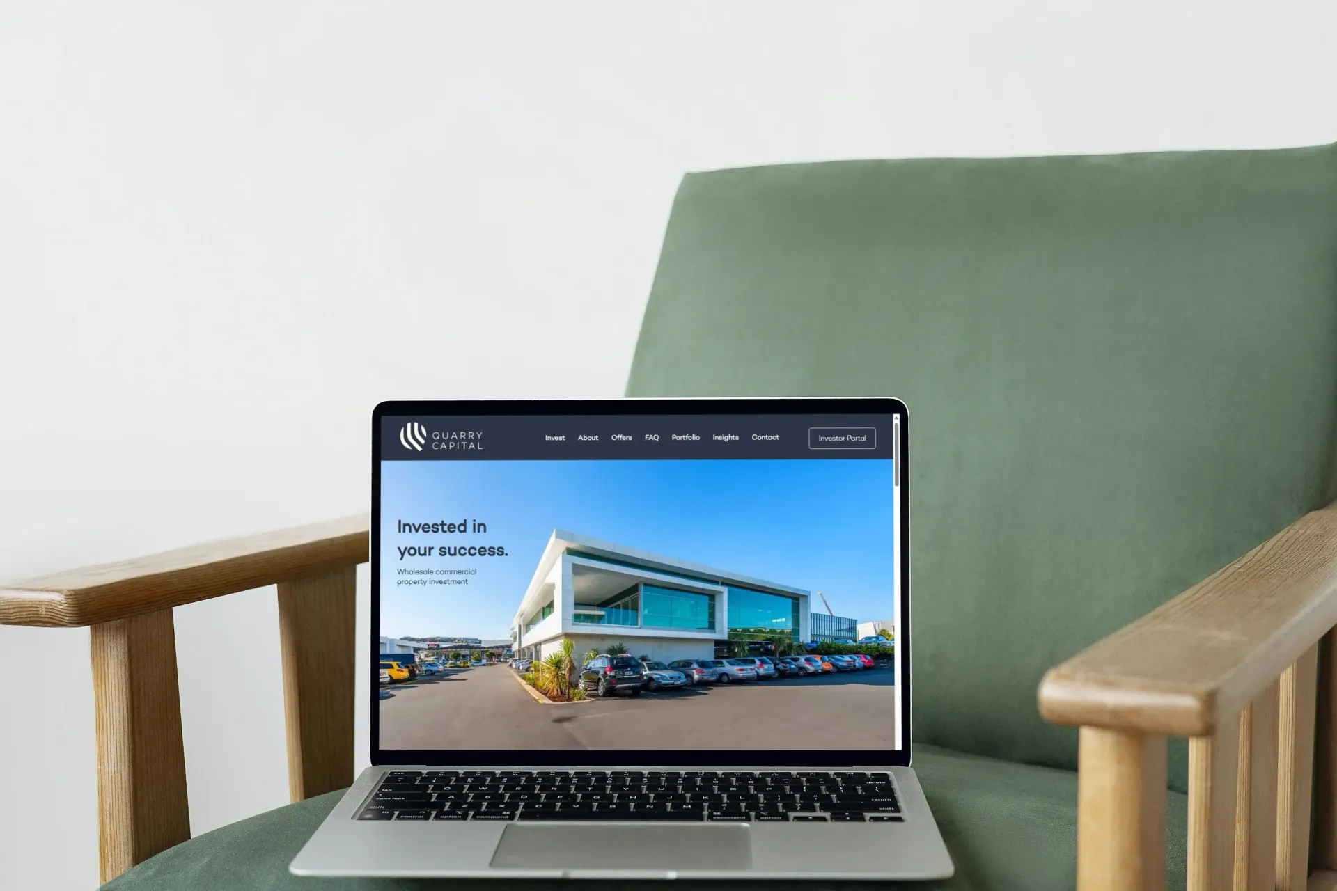 A laptop is sitting on a chair with a website for financial services on it