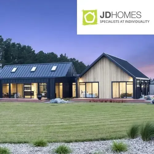 Modern homes with black roofs and wooden siding, green lawn. 