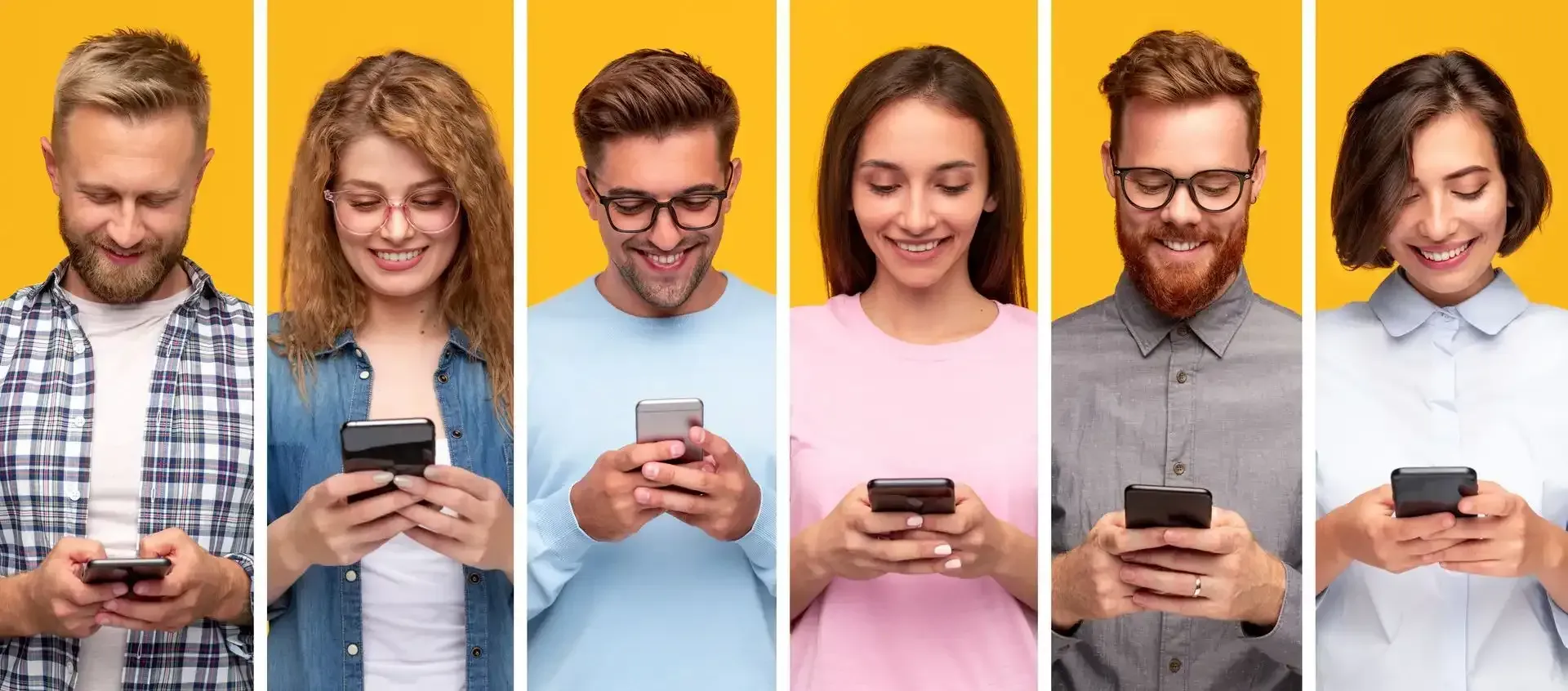 a group of people are standing next to each other looking at their phones .