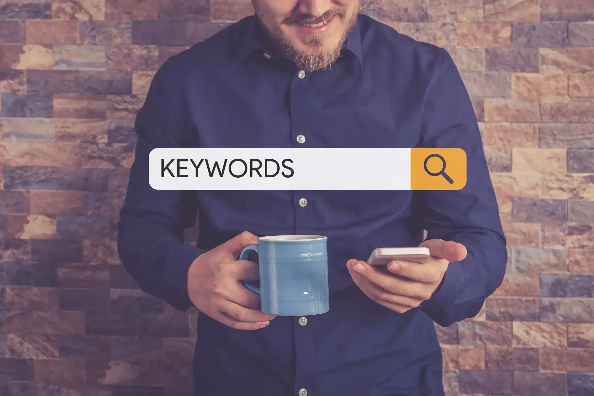a man is holding a cup of coffee and using a cell phone to search for keywords .