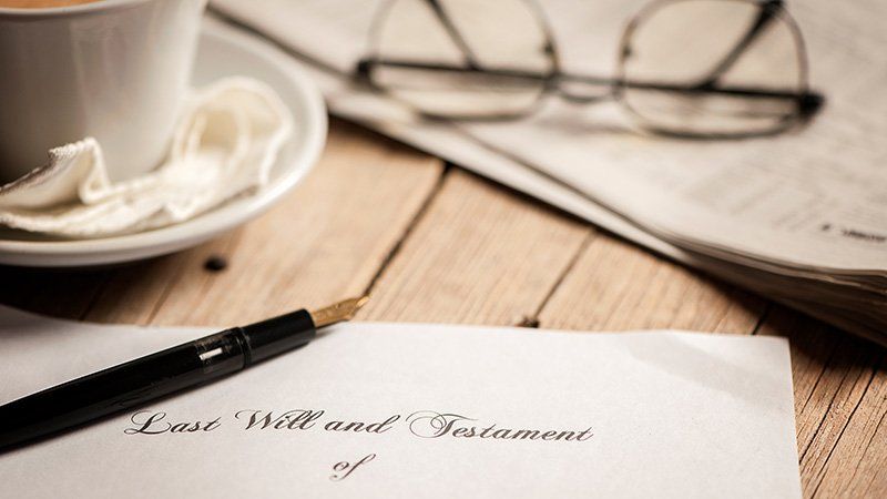 Pen on top of paper that says last will and testament
