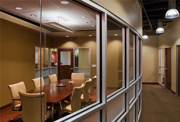 A conference room with a table and chairs in it