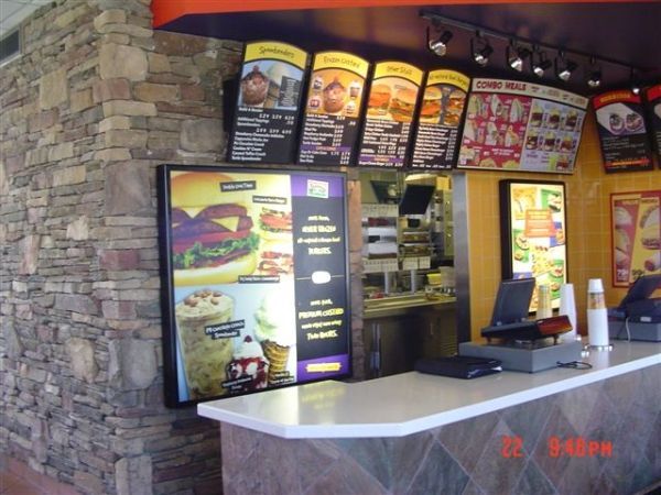 A mcdonald 's restaurant with a brick wall and a counter